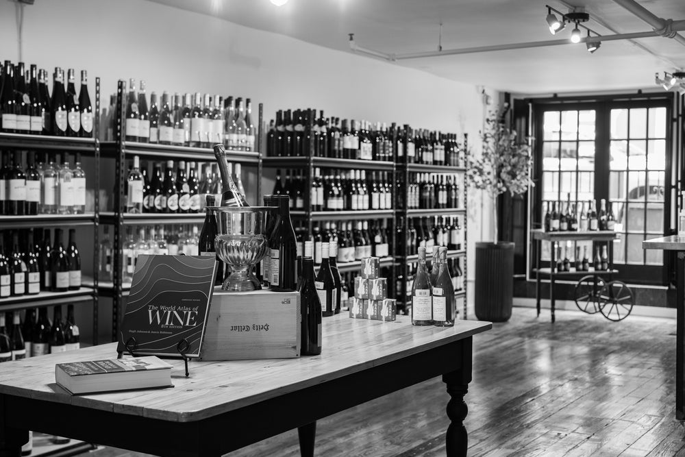 A table set with bottles and an ice bucket inside Pure Wine
